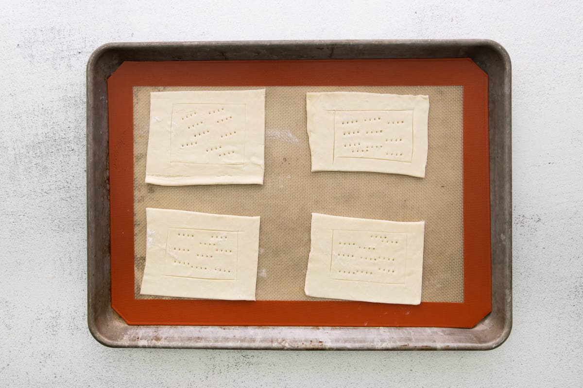 Puff pastry dough rectangles on a baking sheet.