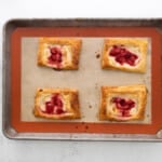 strawberry tarts on a baking sheet.