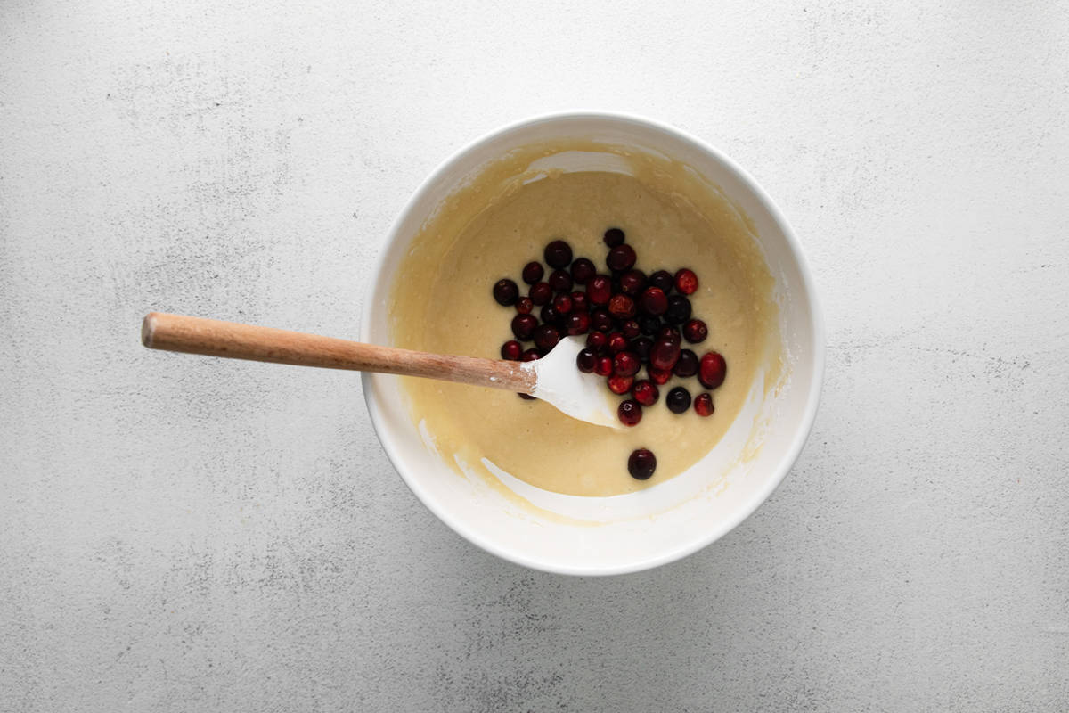 foling cranberries into cupcake batter