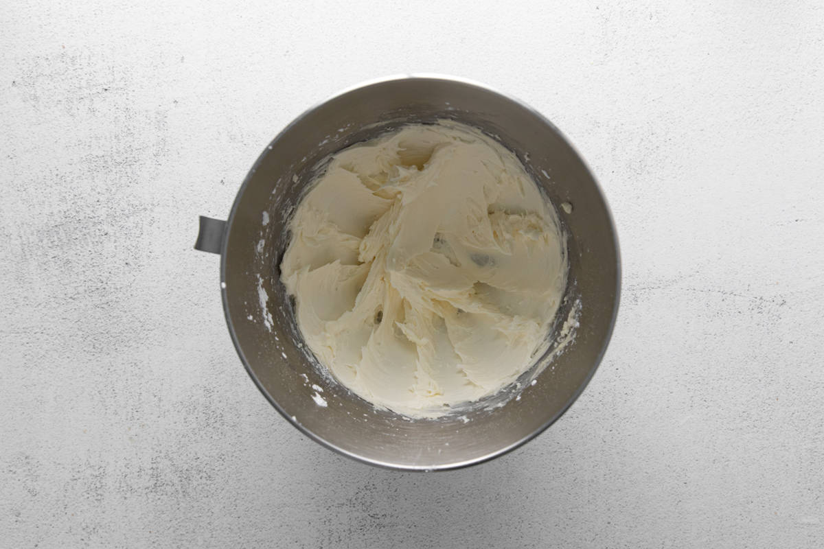 frosting in a silver mixing bowl