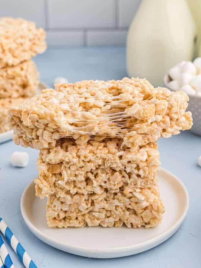 Rice Krispie treats stacked up, the top one is partially pulled apart