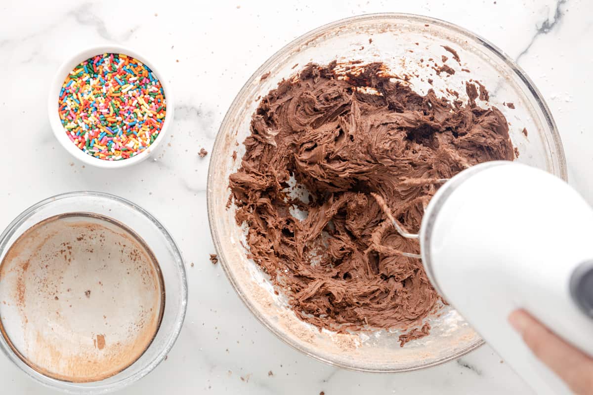 a person mixing ingredients in a bowl.