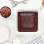 a white baking dish with a chocolate cake in it.