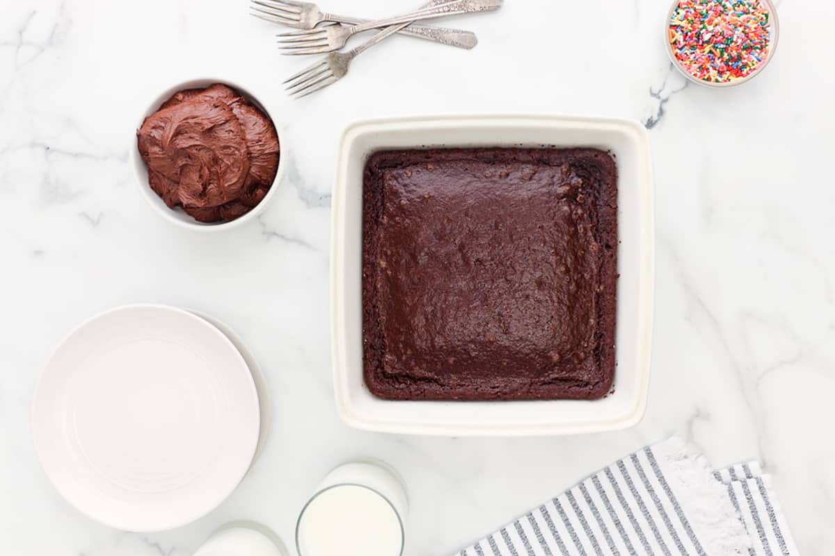 a white baking dish with a chocolate cake in it.