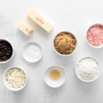 portioned ingredients for peppermint chocolate chip cookies in individual bowls.