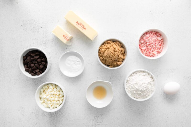 portioned ingredients for peppermint chocolate chip cookies in individual bowls.