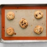 baked chocolate chip peppermint cookies on a baking sheet.