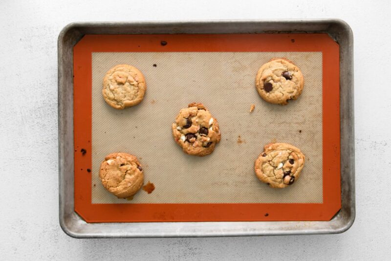 baked chocolate chip peppermint cookies on a baking sheet.