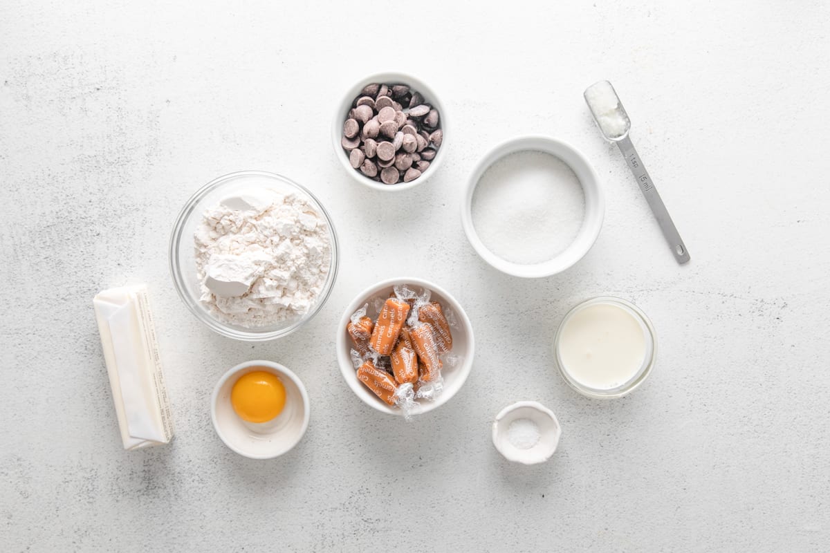 overhead view of ingredients for twix cookies in individual bowls.