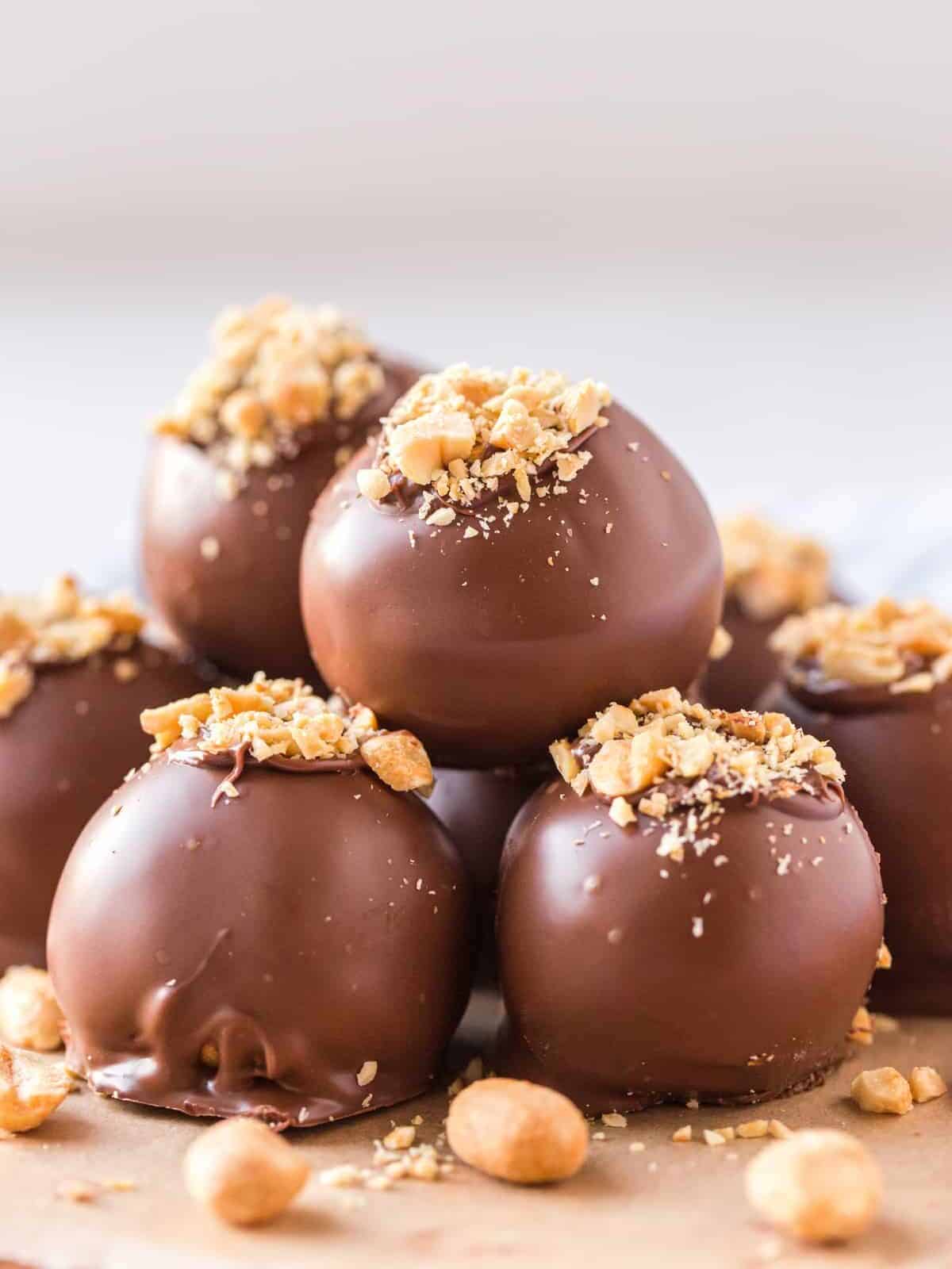 close up on peanut butter balls stacked on top of each other