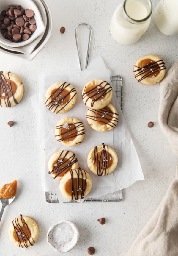 overhead view of 7 twix cookies on parchment paper on a small wire rack.