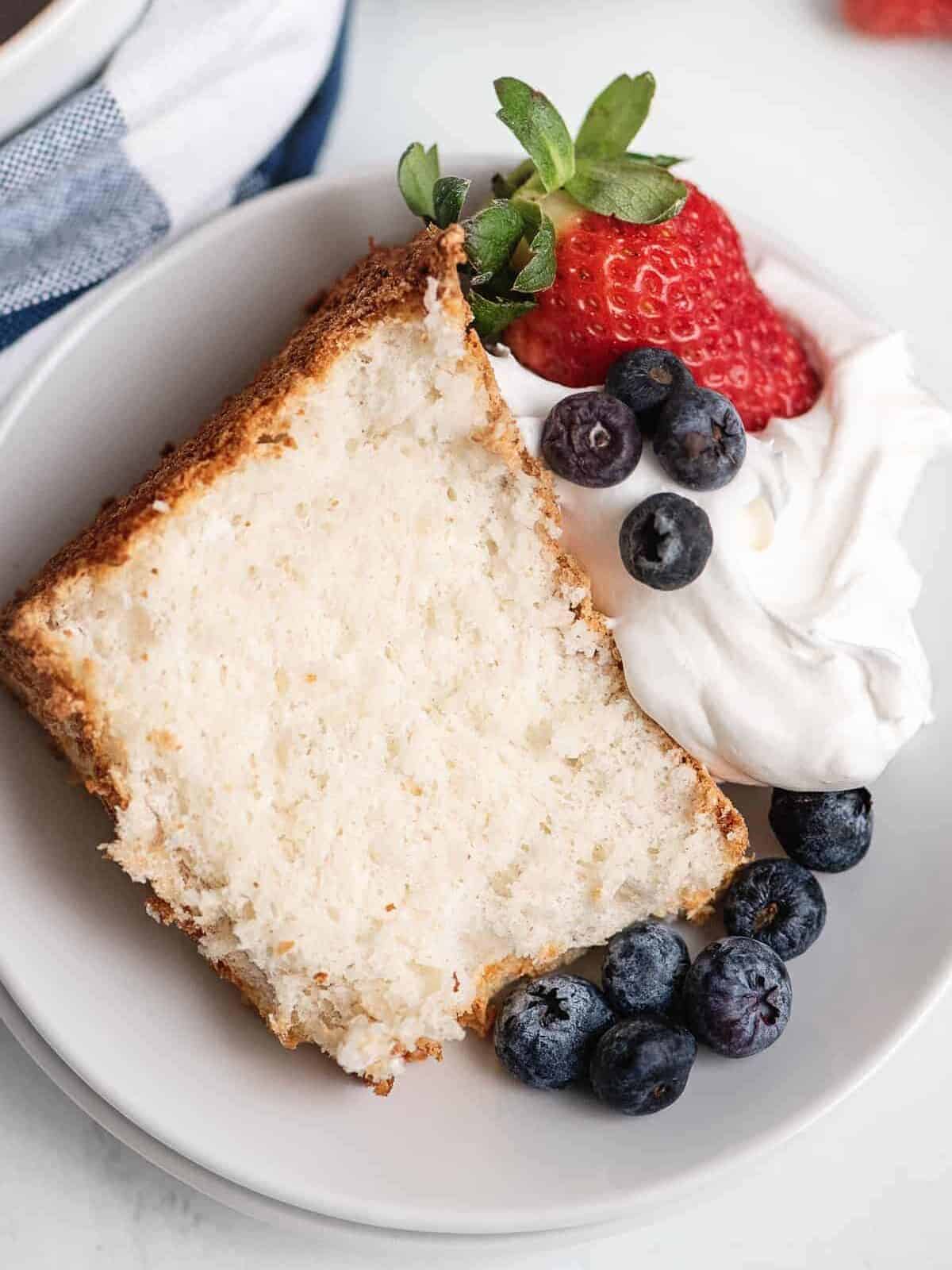 angel food cake topped with berries and cream