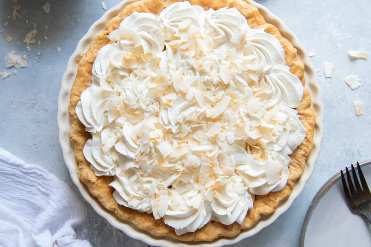 overhead view of a whole coconut cream pie with whipped topping