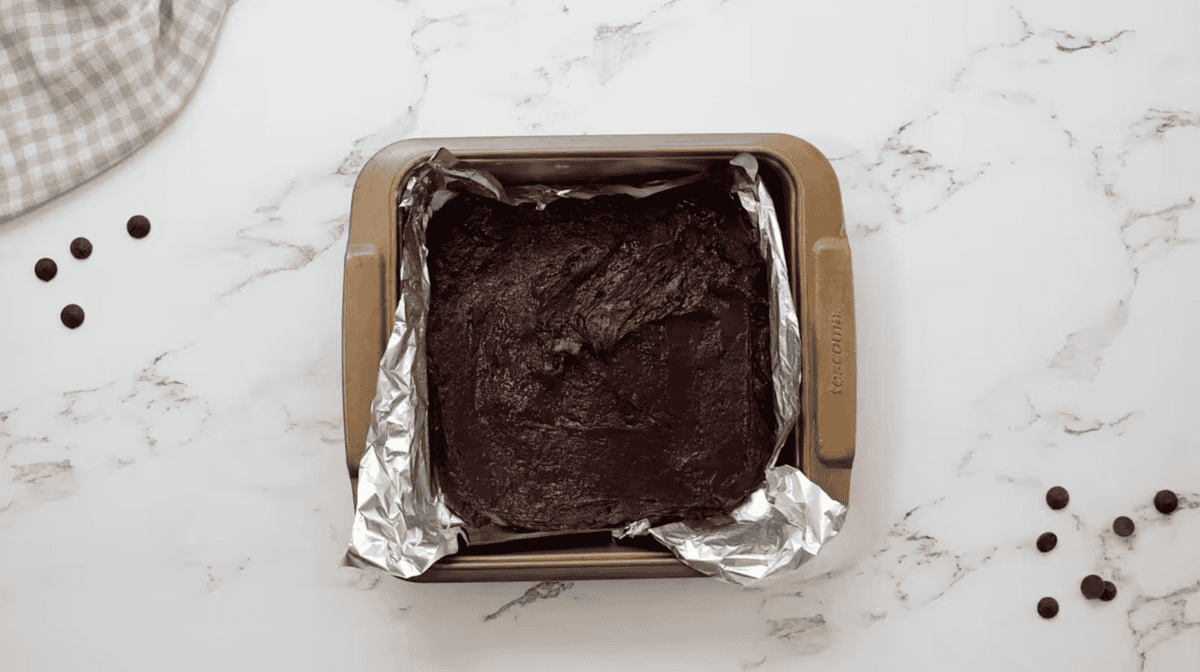 brownie batter in a foil lined baking pan.