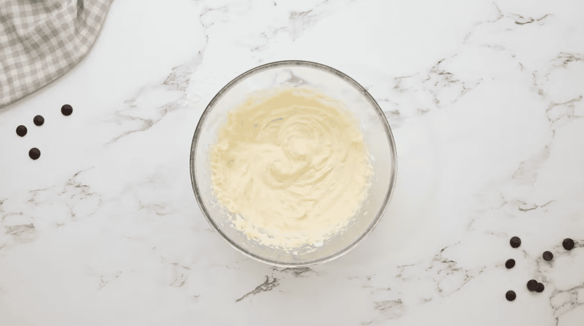 beaten cream cheese in a glass bowl.