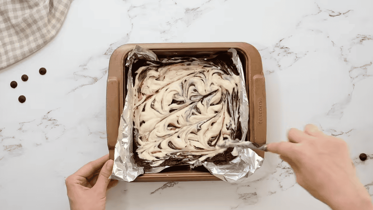 swirling cream cheese into brownie batter with a butter knife.