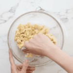 cutting butter into dough with a pastry cutter.