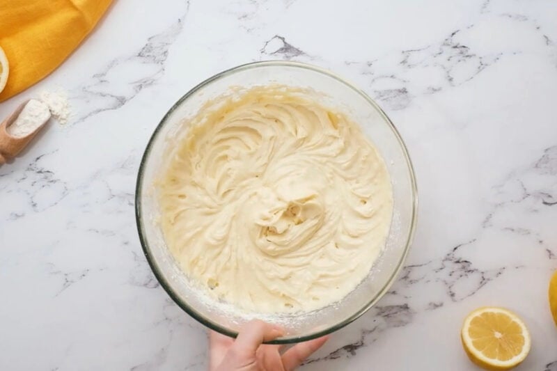thick lemon bundt cake batter in a glass bowl.
