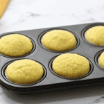 baked lemon cupcakes in a cupcake tin.