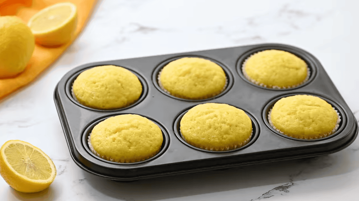 baked lemon cupcakes in a cupcake tin.