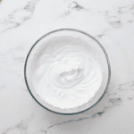 whipped cream in a glass bowl.