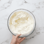 whipped lemon frosting in a glass bowl.