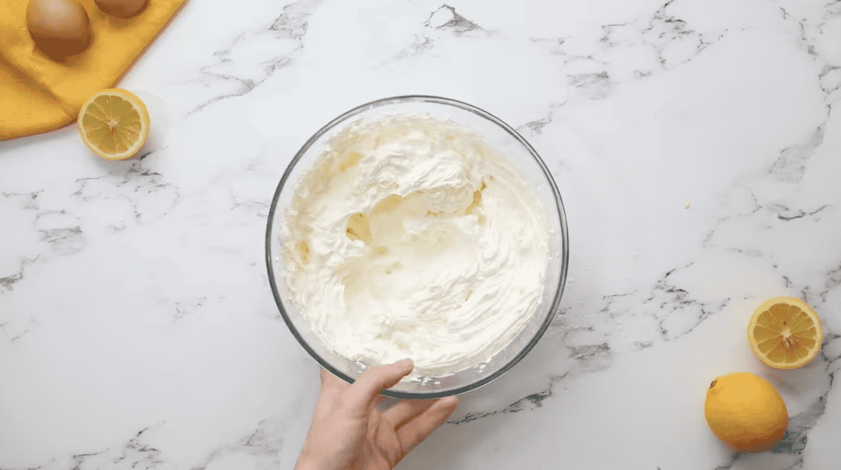 whipped lemon frosting in a glass bowl.