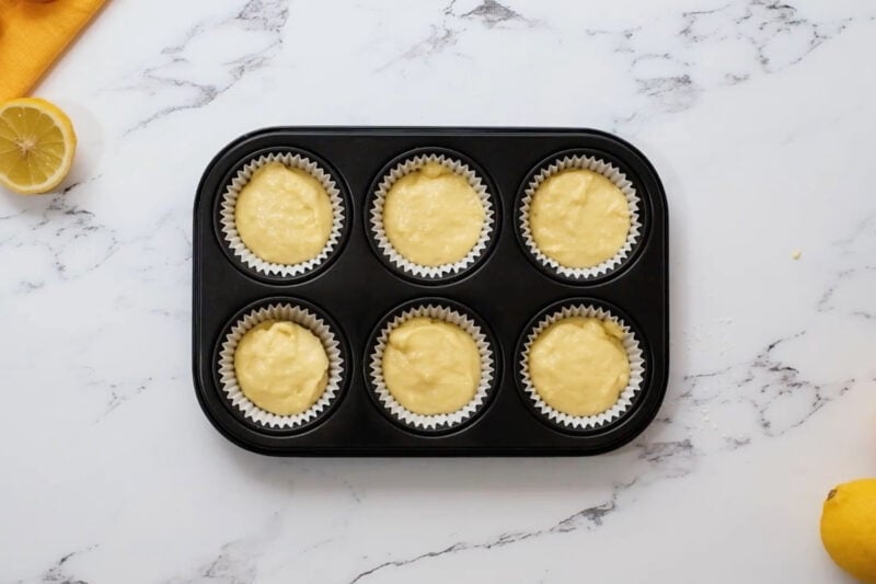 lemon cupcake batter portioned in a cupcake tin.