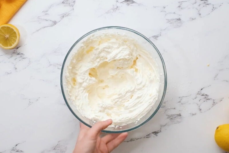 lemon whipped cream frosting in a glass bowl.