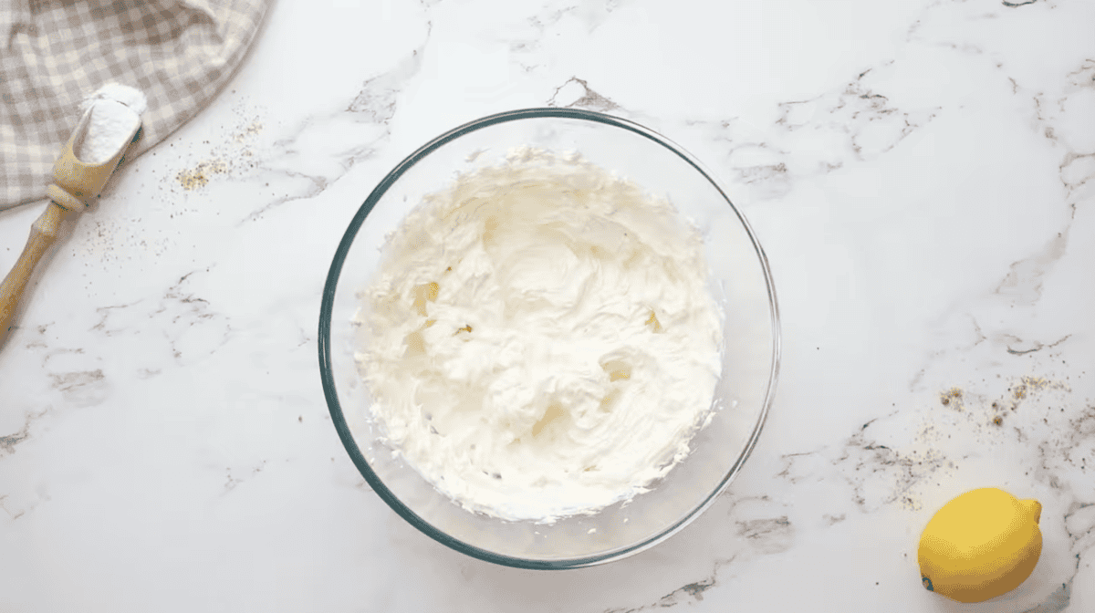 beaten cream cheese in a glass bowl.