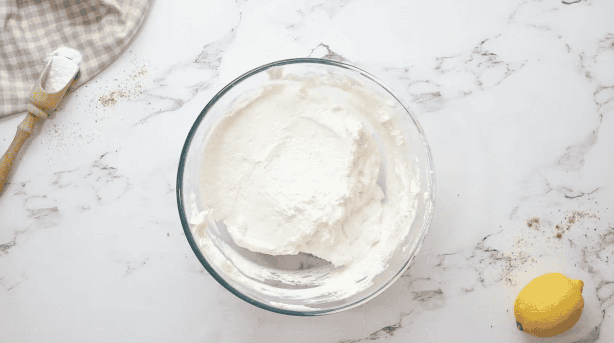 lemon cheesecake filling in a glass bowl.