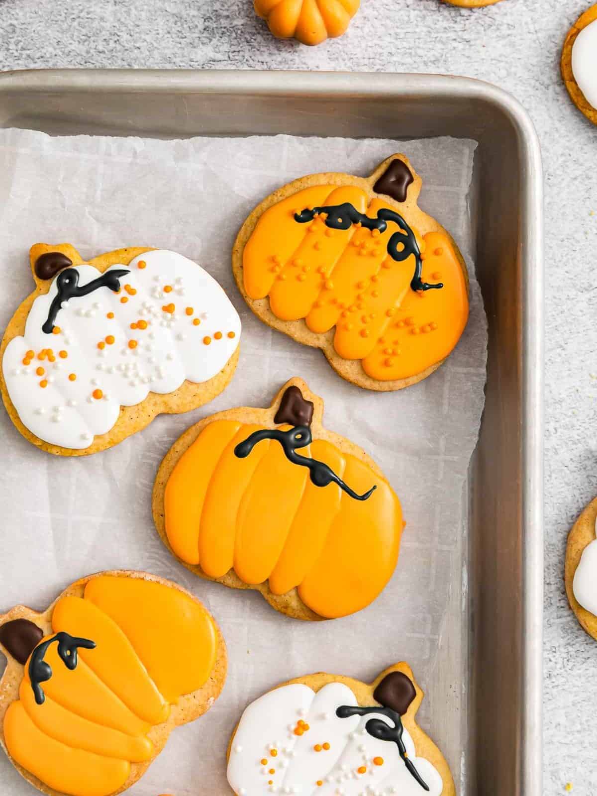 pumpkin sugar cookies on a baking tray