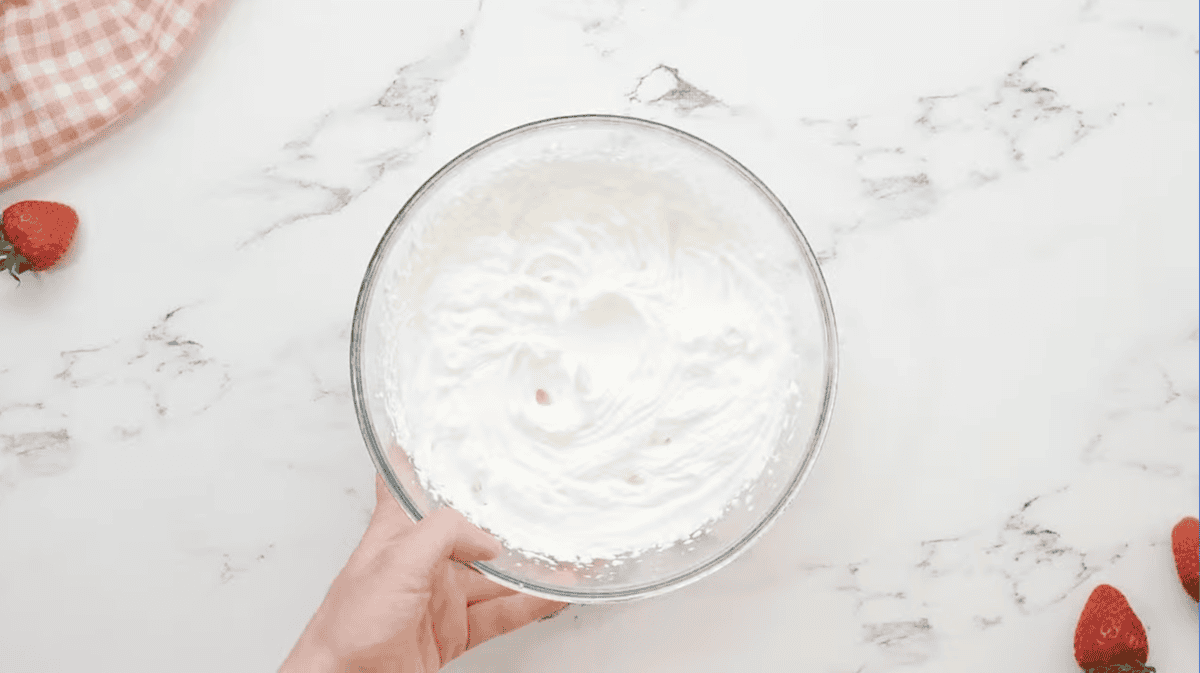 whipped cream in a glass bowl.