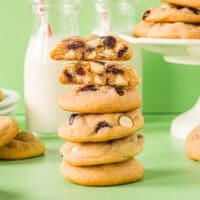 a halved white chocolate cranberry cookie on top of a stack of cookies.