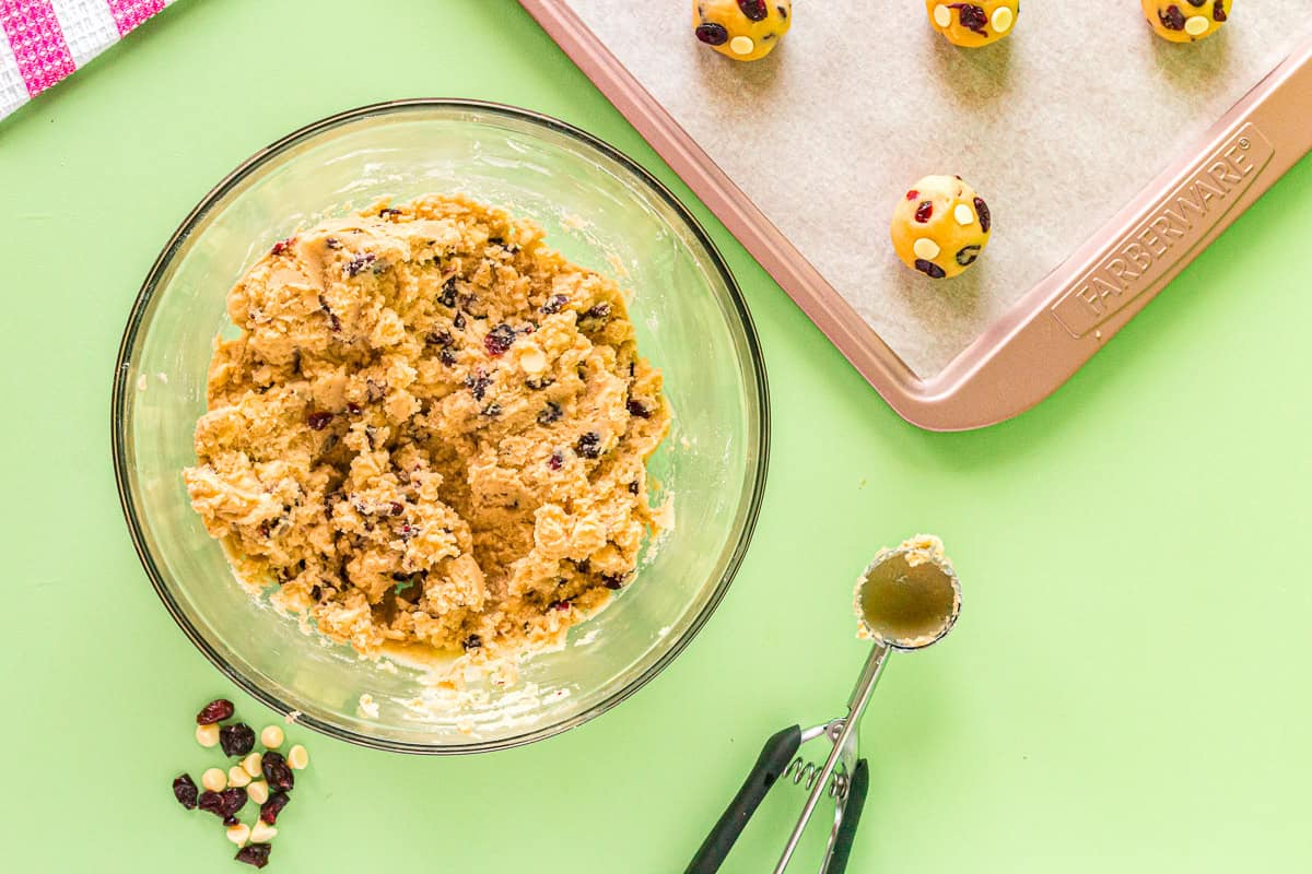 white chocolate cranberry cookie dough in a glass bowl.