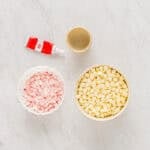 measured ingredients for white chocolate peppermint bark in individual bowls.