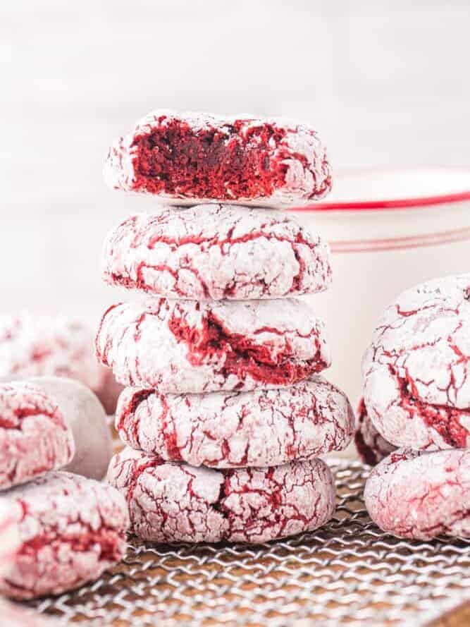 a stack of red velvet crinkle cookies