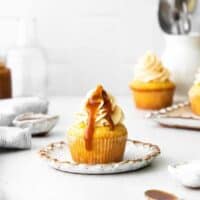 caramel cupcakes with caramel sauce on a white plate.