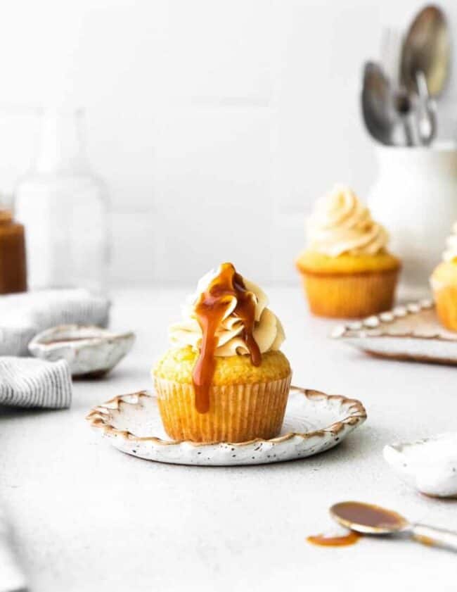 caramel cupcakes with caramel sauce on a white plate.