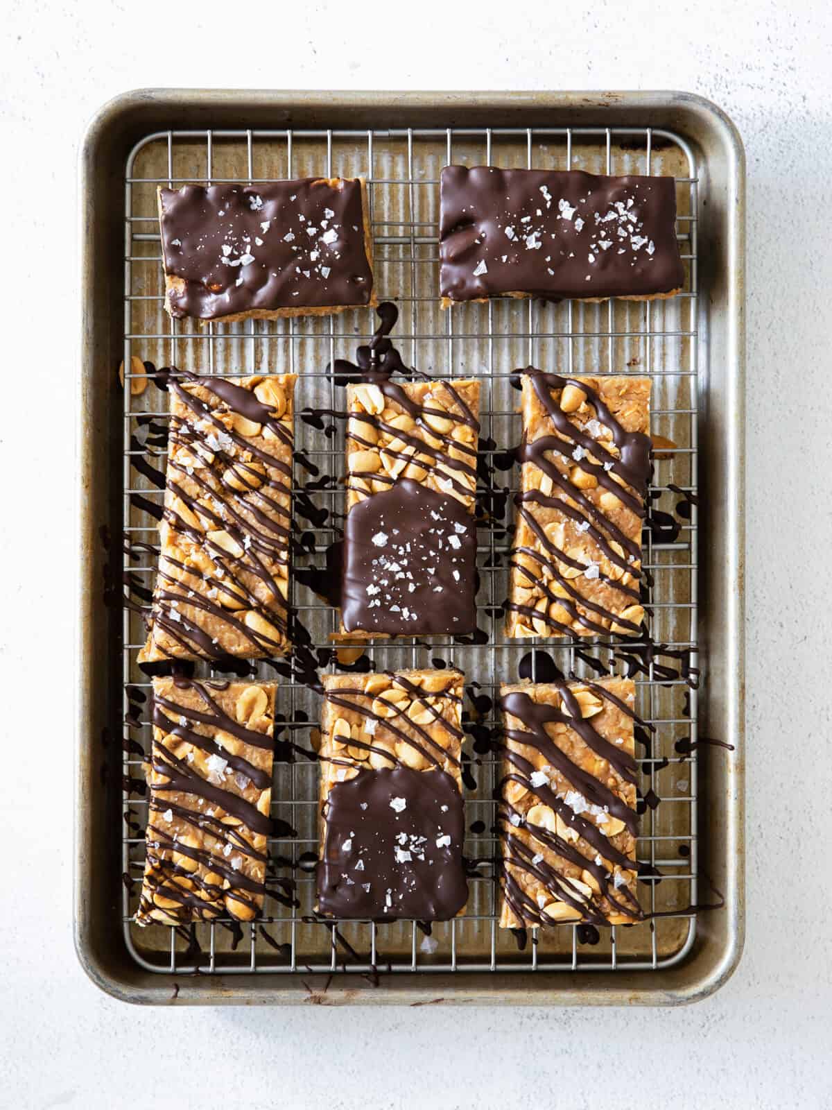 chocolate peanut butter bars on a baking sheet.