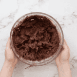 chocolate buttercream frosting in a glass bowl.