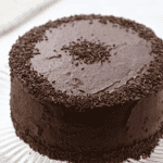 frosted devil's food cake on a cake stand.