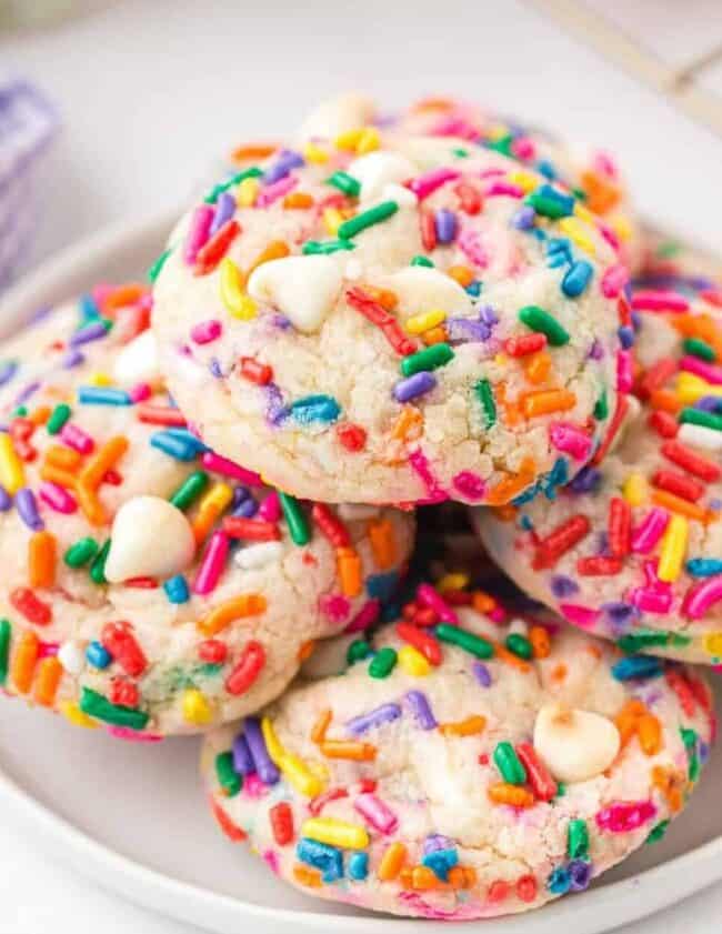 stacked funfetti cookies on white plate