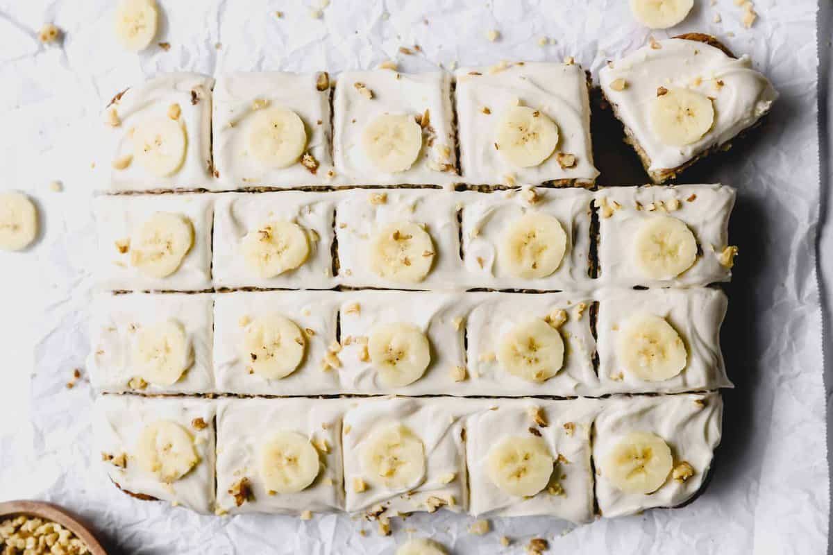 overhead view of banana cake cut into 20 slices with the bottom right corner slice askew.