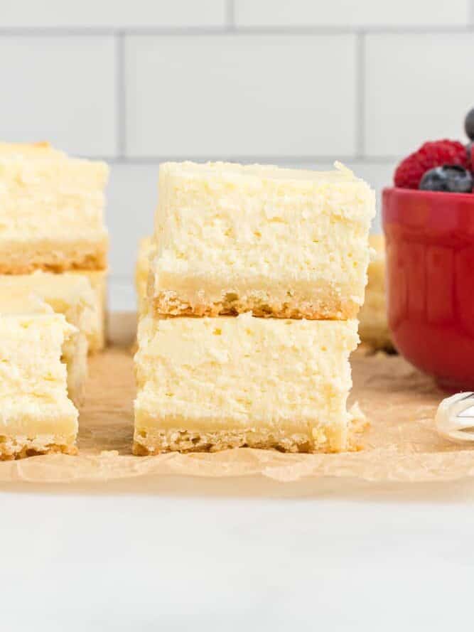 side view of 2 stacked cheesecake bars.