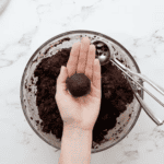 a chocolate cake truffle in a hand.
