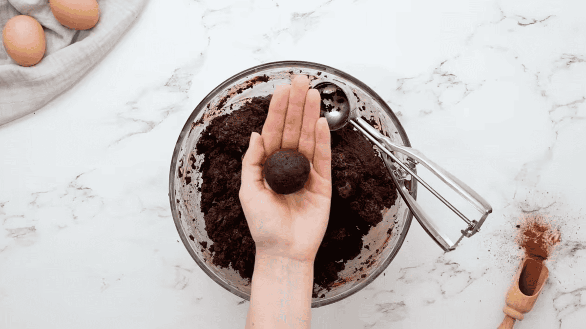 a chocolate cake truffle in a hand.