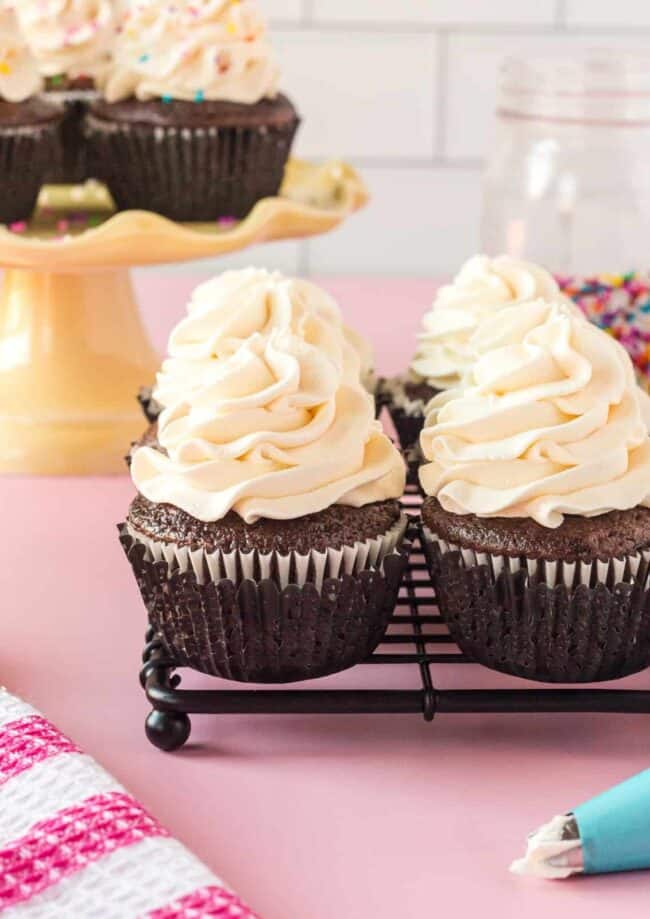 a group of cupcakes with white frosting on top.