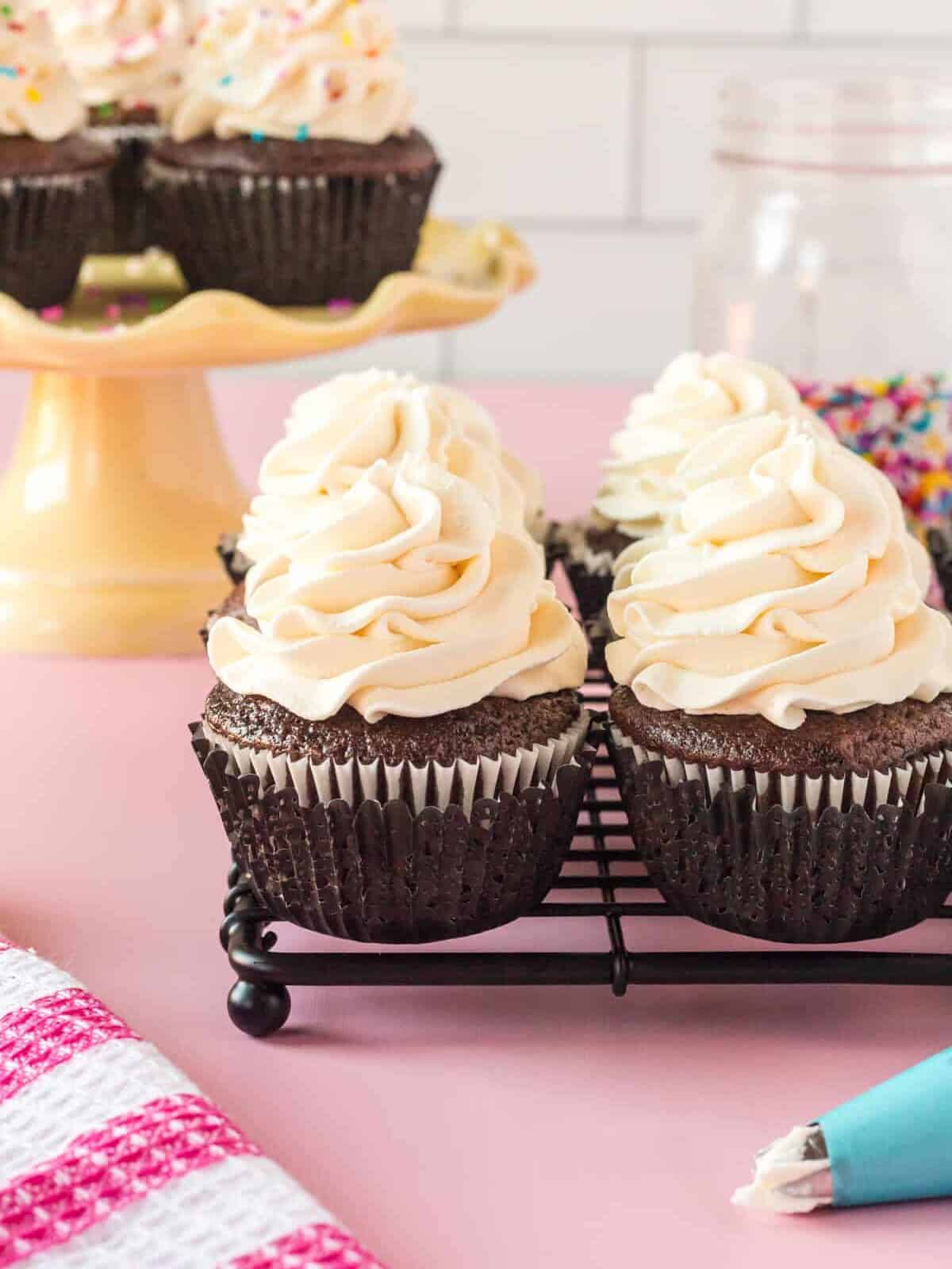 a group of cupcakes with white frosting on top.