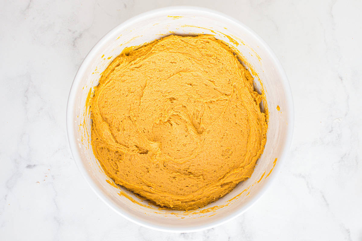 pumpkin snickerdoodle cookie dough in a white bowl.